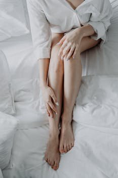 Woman in White Dress Shirt Lying on Bed